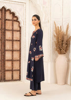 Close-up detail of heavy floral embroidery on midnight navy linen shirt