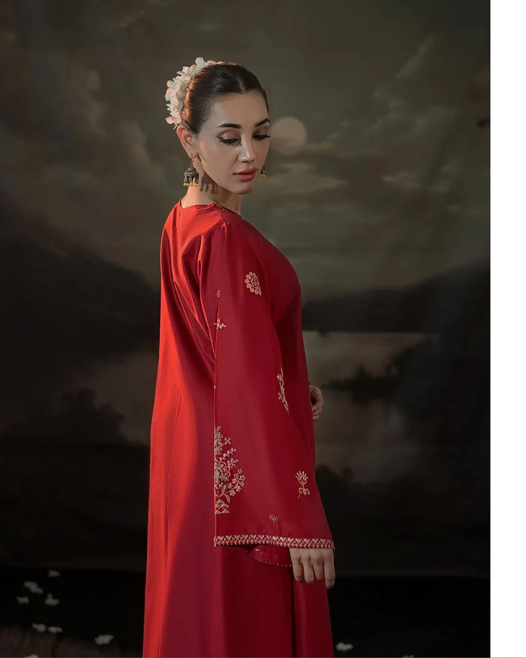 Close-up of delicate embroidery on crimson fabric 2-piece suit