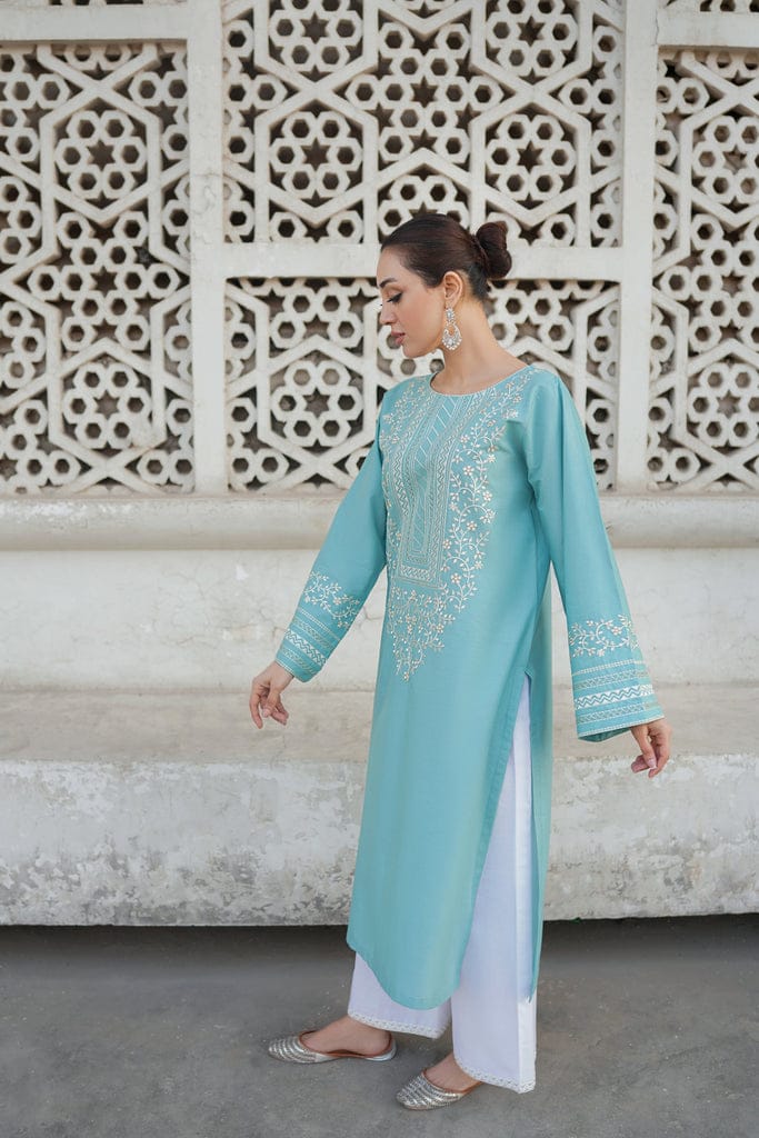 Close-up of white thread embroidery on powder blue shirt front