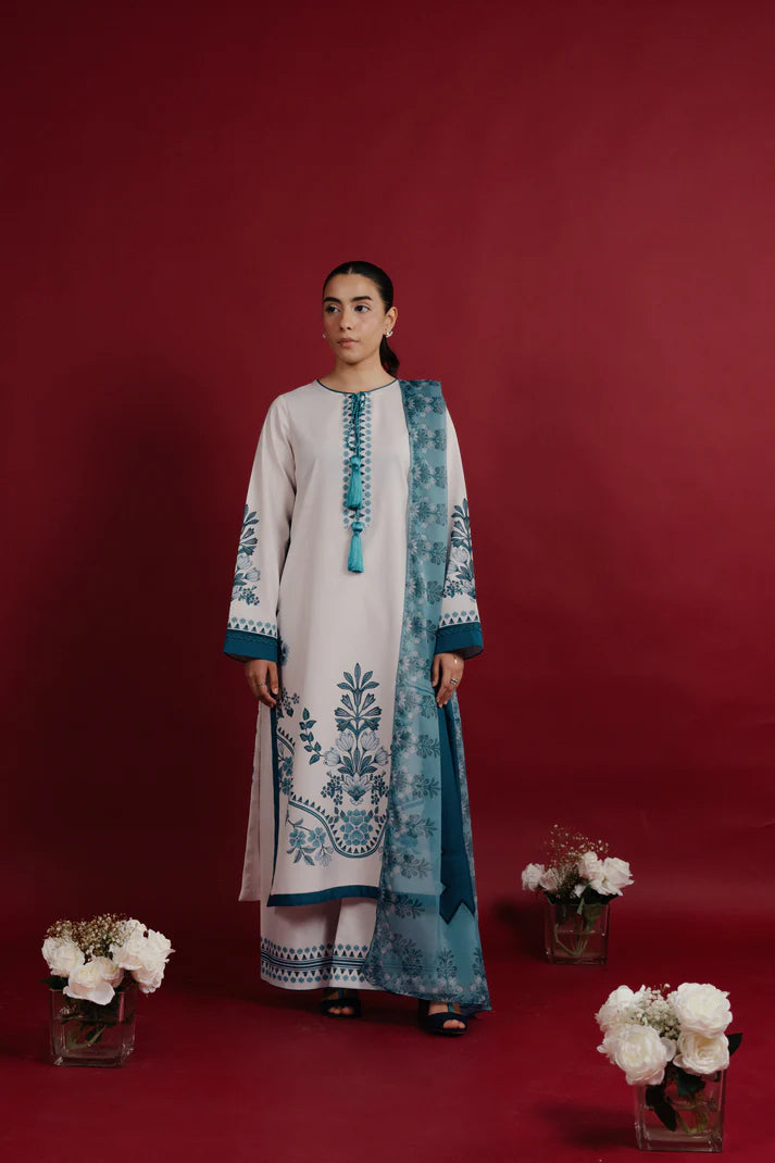 Close up of teal printed neckline with tassel detail