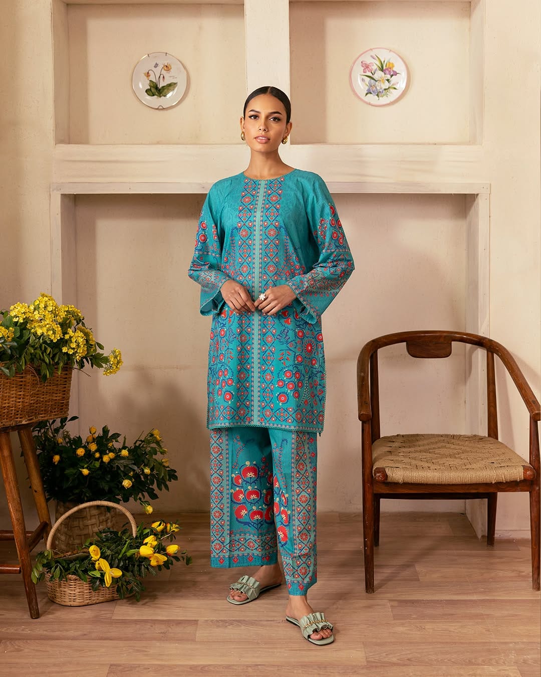 Full-length model wearing ZAMARANG’s teal blue 2-piece sui