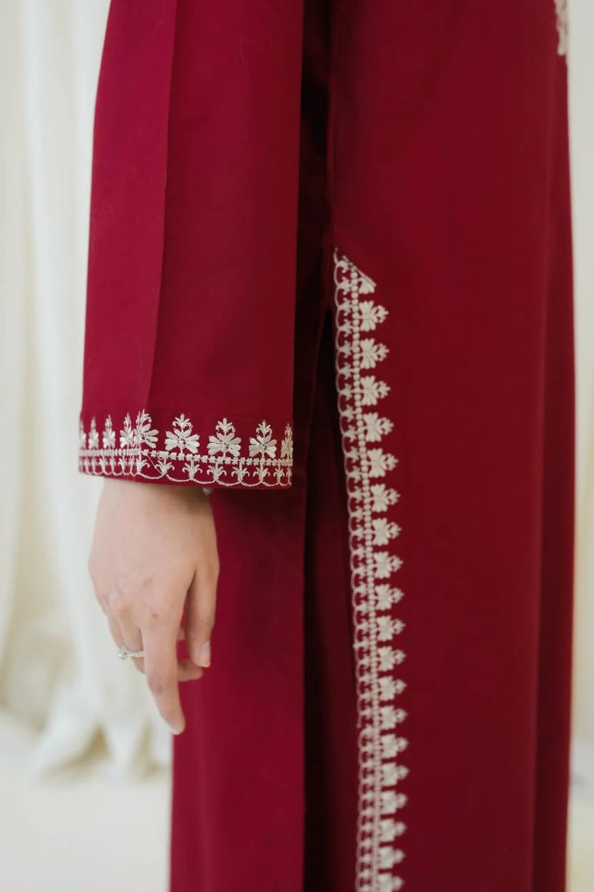 Model wearing deep burgundy embroidered linen 2-piece suit
