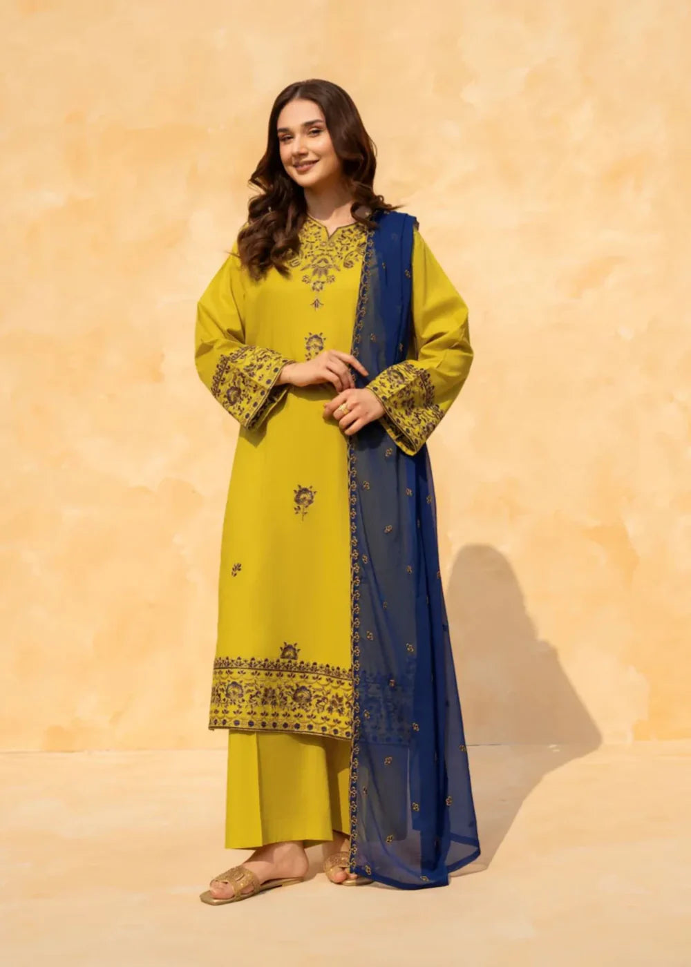 Close up of embroidered neckline and sleeve on lime green lawn shirt