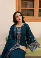 Close-up of teal embroidered neckline and sleeve design