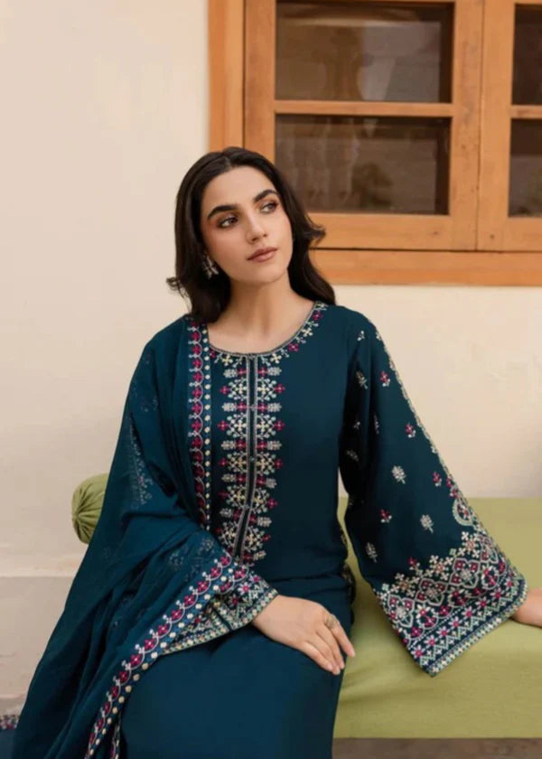 Close-up of teal embroidered neckline and sleeve design